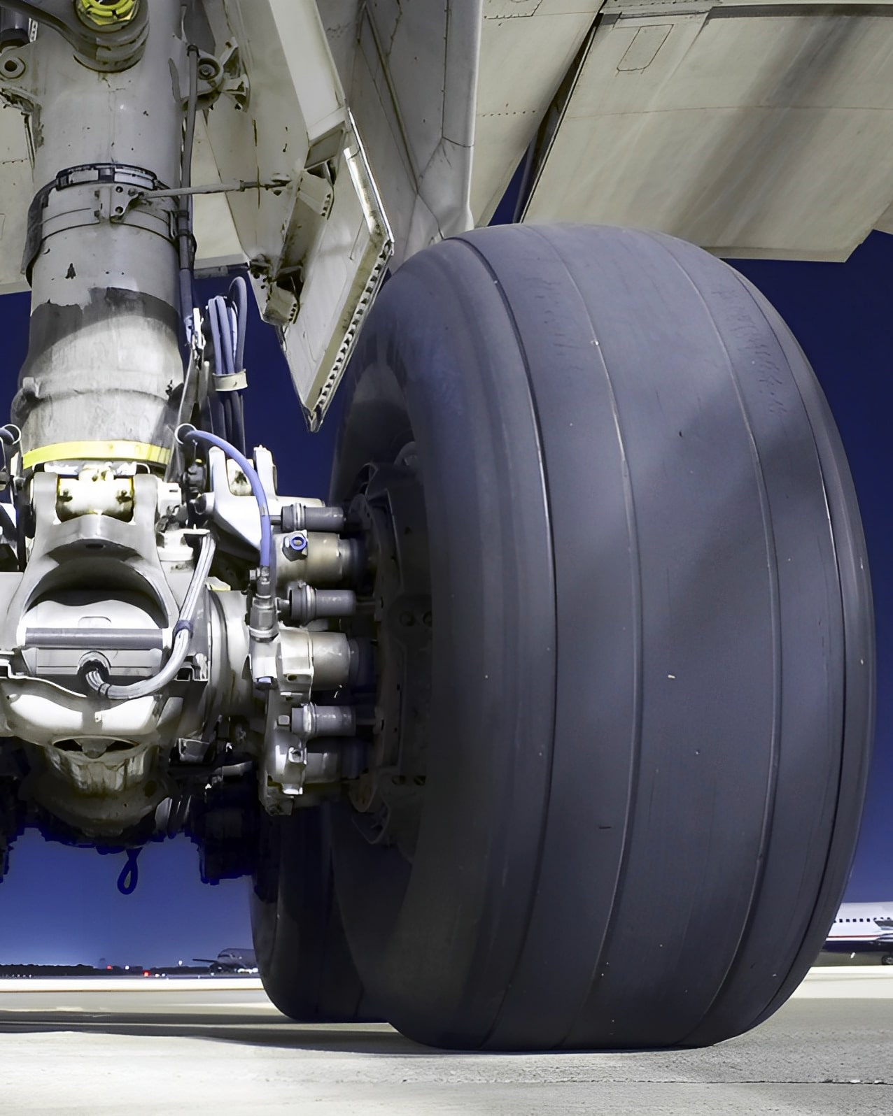 Close-up front view of DC-10 main landing gear on left and large tire on right